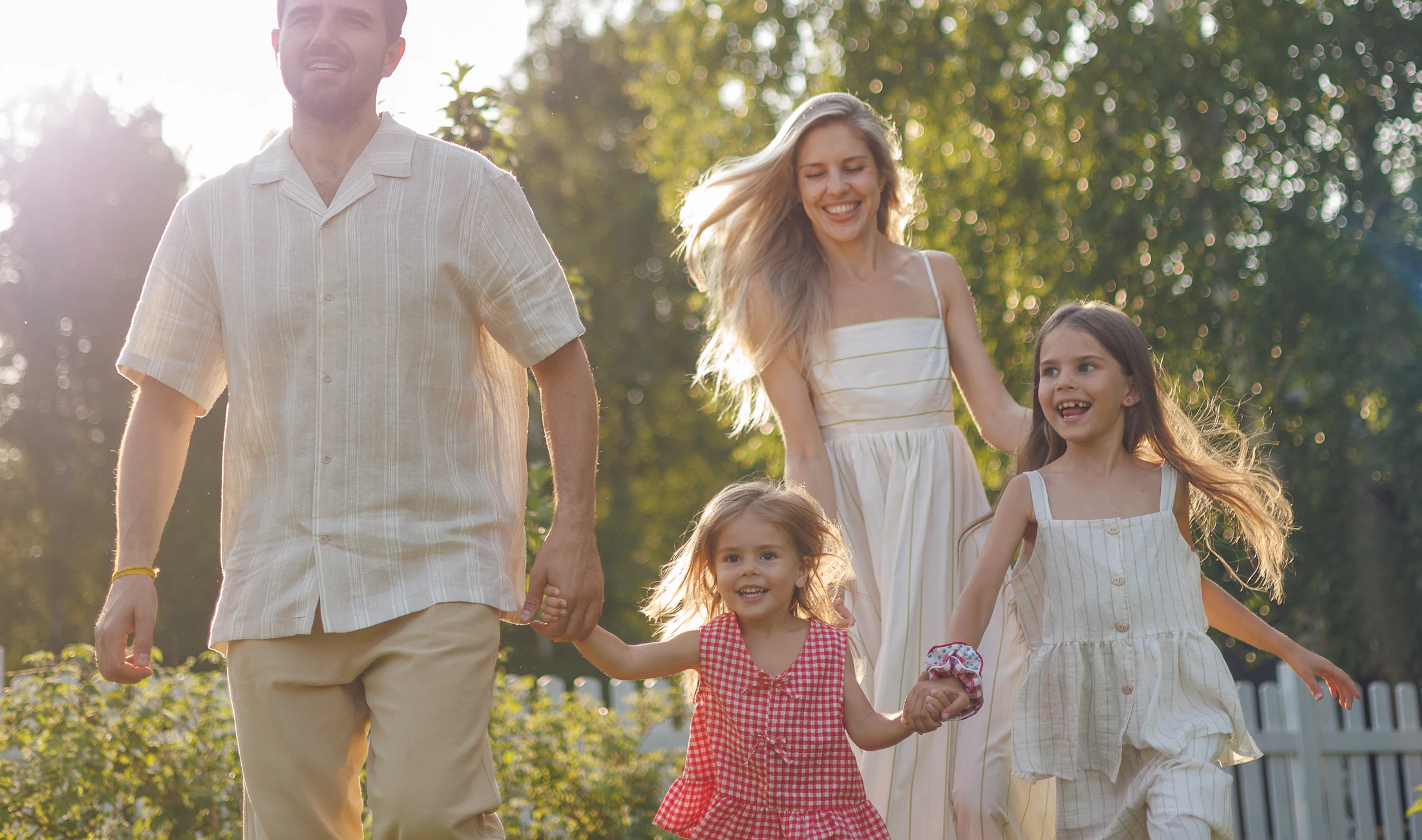 A happy family walking together in a sunlit garden